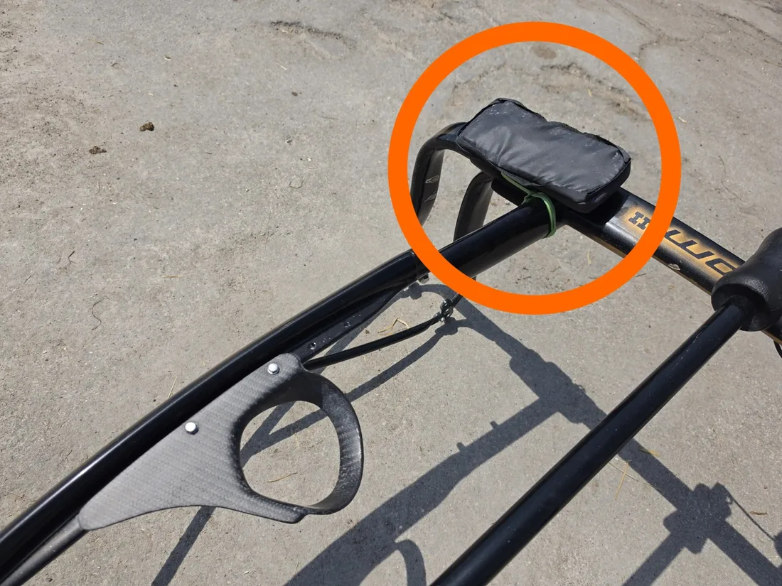 Close-up of the RTK GNSS receiver pouch mounted on a sulky shaft